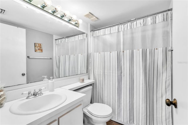 bathroom with a shower with curtain, vanity, and toilet