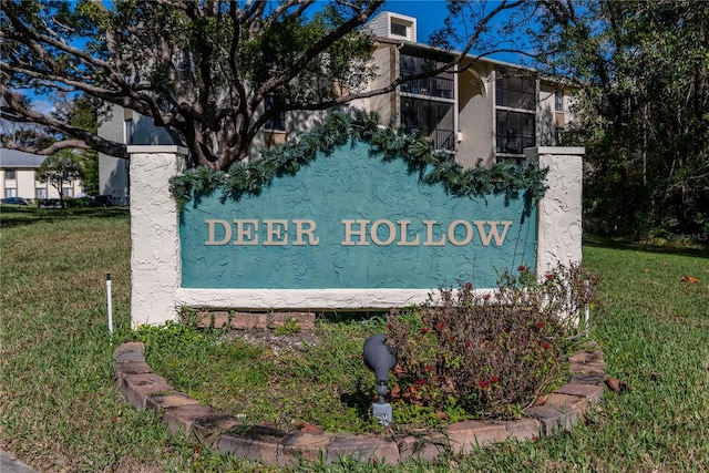 community / neighborhood sign with a lawn