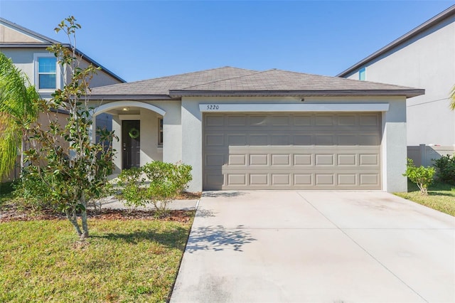 view of front of house featuring a garage and a front yard