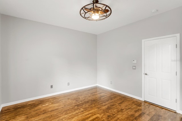 spare room with ceiling fan and wood-type flooring