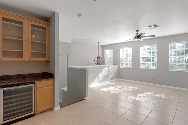 kitchen featuring wine cooler, ceiling fan, light tile patterned floors, and pendant lighting