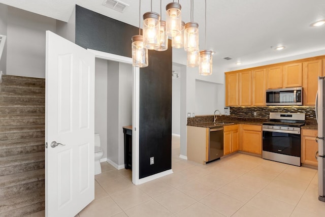 kitchen with decorative backsplash, stainless steel appliances, sink, decorative light fixtures, and light tile patterned flooring