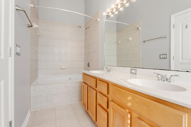 bathroom with tile patterned floors, vanity, and tiled shower / bath