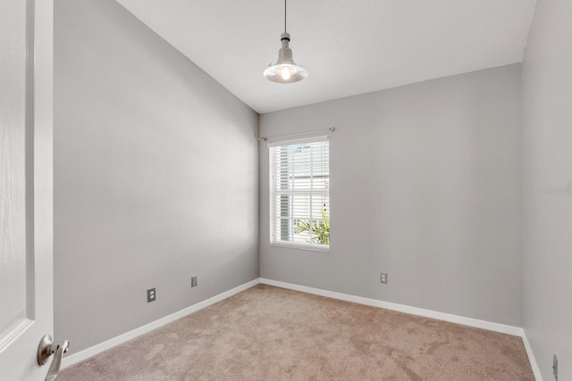 unfurnished room featuring light colored carpet