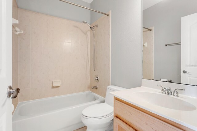 full bathroom featuring vanity, toilet, and tiled shower / bath