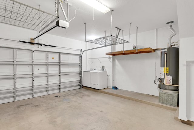 garage featuring washer and clothes dryer, a garage door opener, and gas water heater