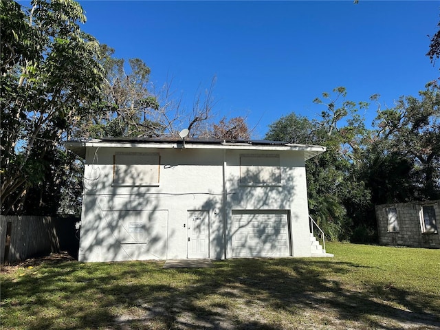 view of outdoor structure with a lawn and a garage