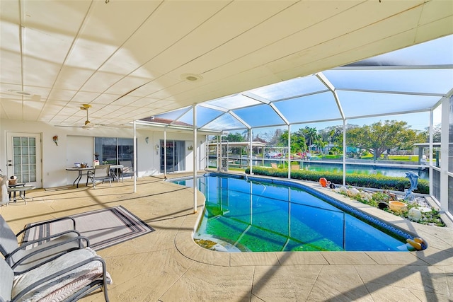 view of pool with a patio, a water view, and a lanai