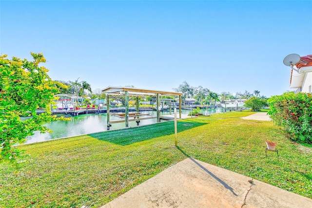 dock area with a water view and a lawn