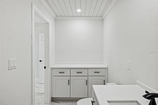 bathroom featuring vanity, toilet, and ornamental molding