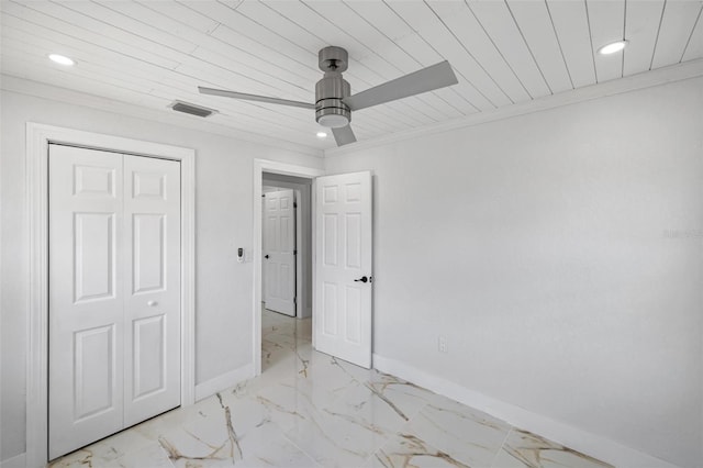 unfurnished bedroom featuring wood ceiling, a closet, crown molding, and ceiling fan