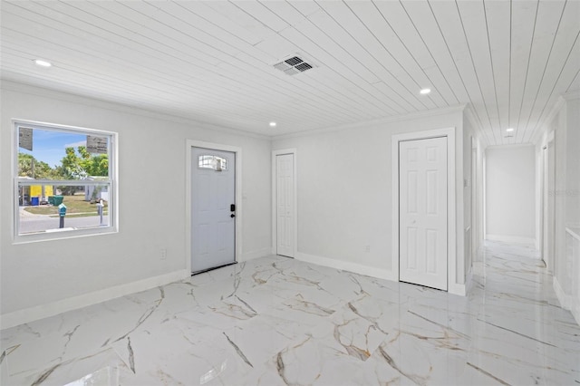 entryway with wood ceiling and crown molding