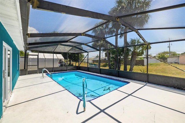 view of swimming pool featuring a lanai and a patio area