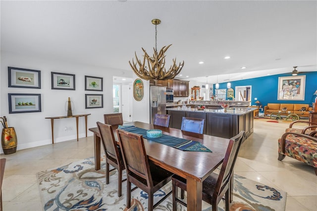 dining area featuring light tile patterned floors and an inviting chandelier