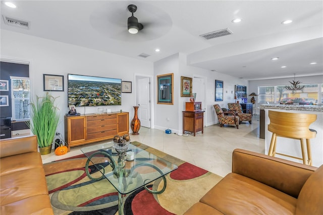 living room with ceiling fan and light tile patterned flooring