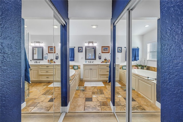 bathroom featuring vanity and shower with separate bathtub