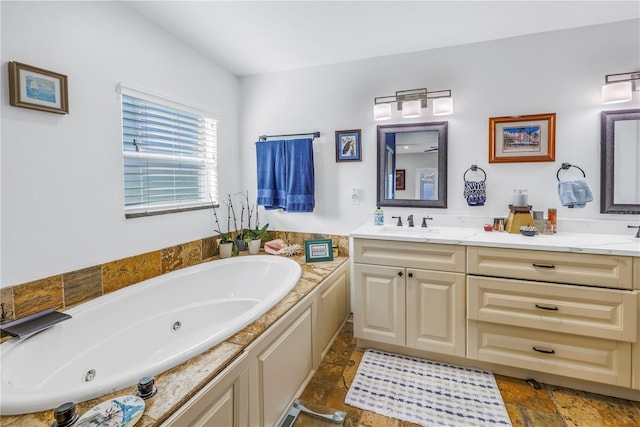 bathroom featuring a washtub and vanity