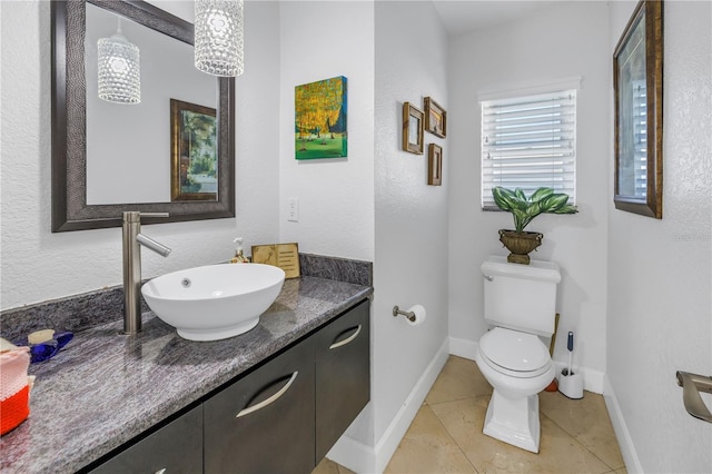 bathroom featuring tile patterned floors, vanity, and toilet