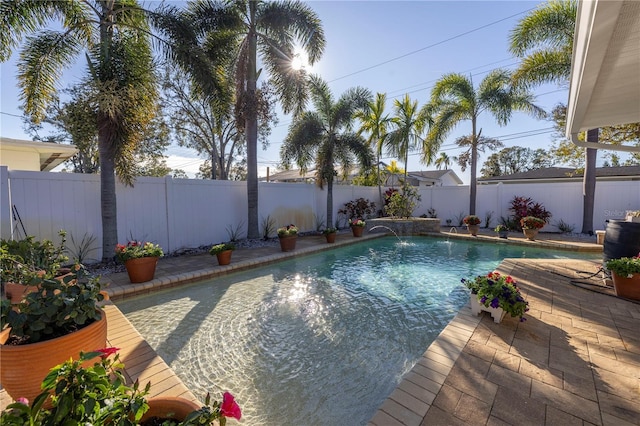 view of pool featuring pool water feature and a patio area