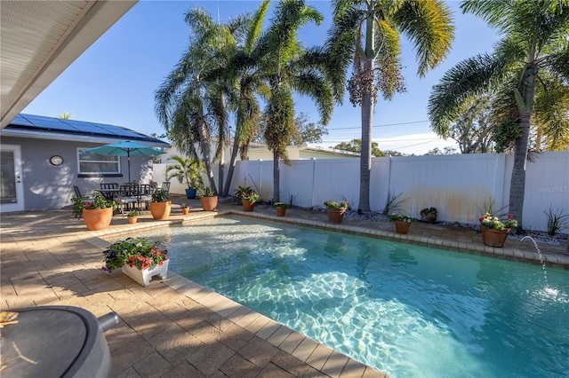 view of swimming pool featuring pool water feature and a patio area