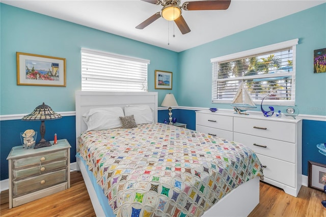 bedroom with ceiling fan and light wood-type flooring