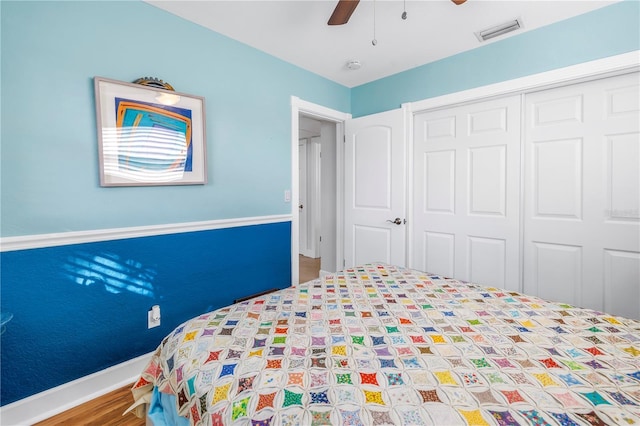 unfurnished bedroom with hardwood / wood-style flooring, ceiling fan, and a closet