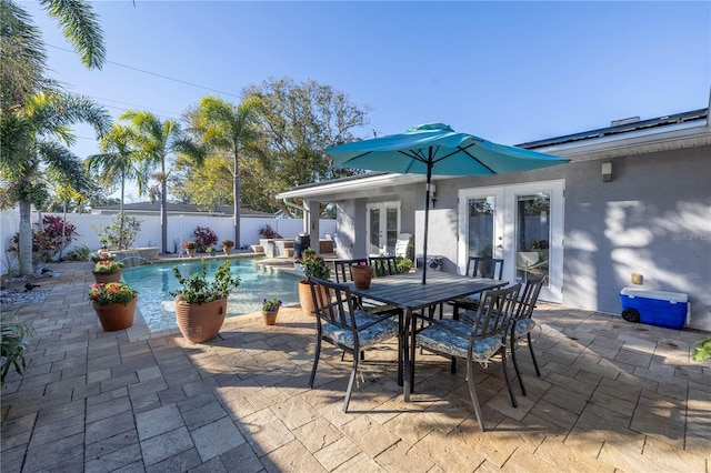 view of patio with french doors and a fenced in pool