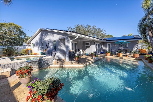 view of swimming pool with an in ground hot tub and a patio