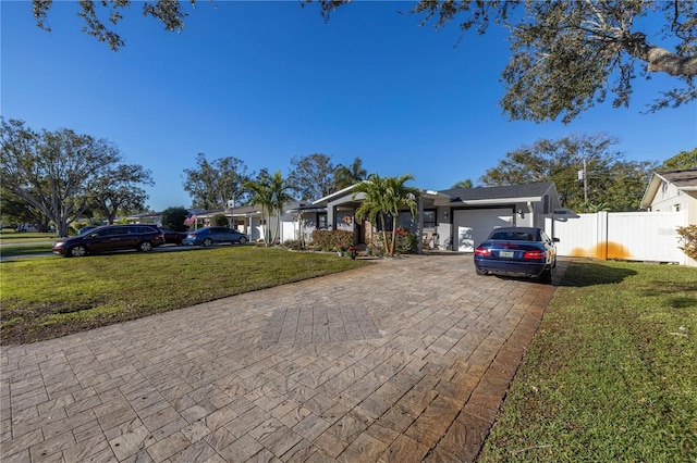 single story home featuring a front yard and a garage