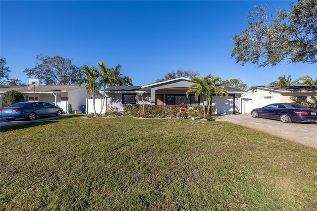 ranch-style home with a garage and a front lawn