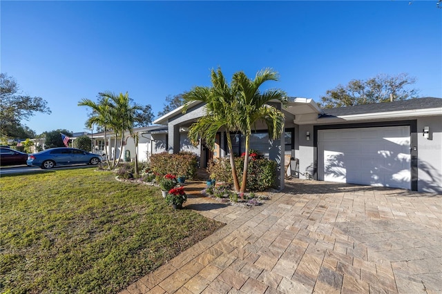 ranch-style home featuring a front lawn and a garage