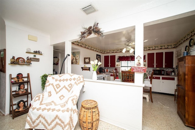 kitchen with ceiling fan, decorative backsplash, and kitchen peninsula