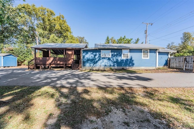 ranch-style home with a storage shed