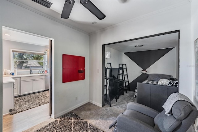 carpeted living room with crown molding, sink, and ceiling fan