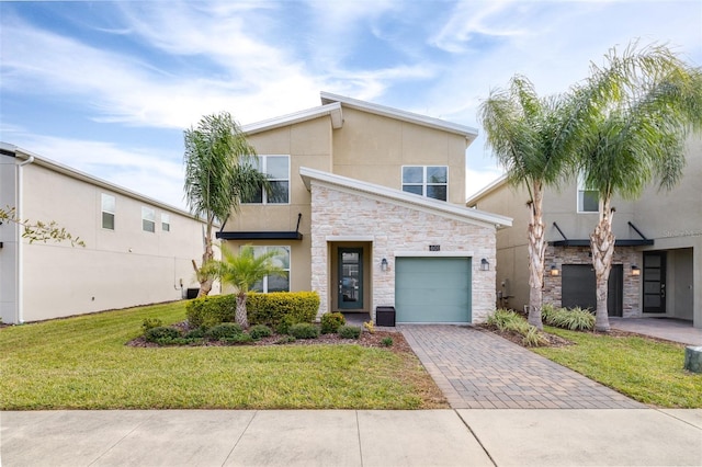 601 Drop Shot Dr, Davenport, FL 33896 - mid-century inspired home with stone siding, stucco siding, decorative driveway, and a front lawn
