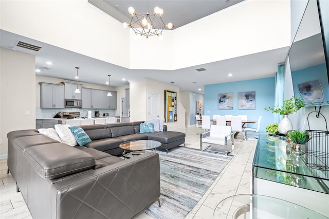 living room with a chandelier and a high ceiling