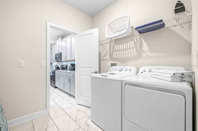 601 Drop Shot Dr, Davenport, FL 33896 - laundry area with independent washer and dryer and light marble finish floors
