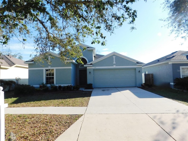 single story home with a garage and a front lawn