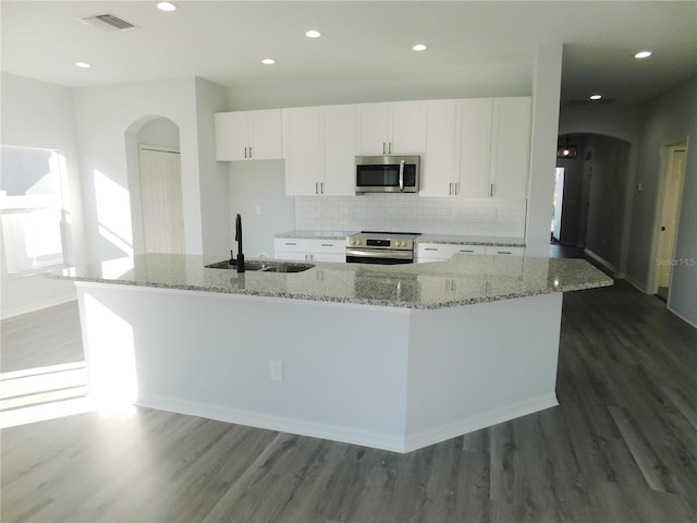 kitchen with sink, a spacious island, white cabinetry, and stainless steel appliances