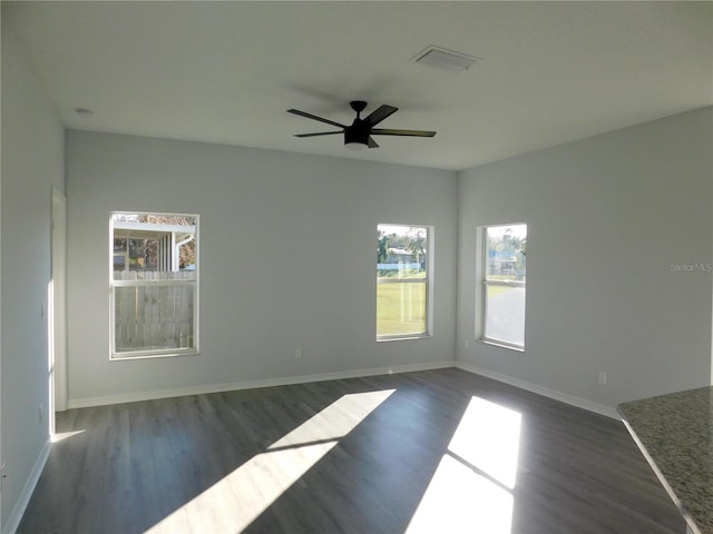 unfurnished room featuring dark hardwood / wood-style floors and ceiling fan