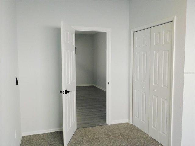 corridor with dark colored carpet