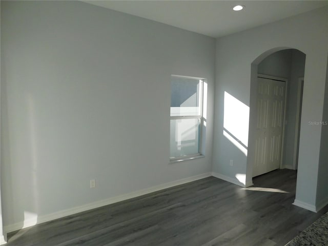 unfurnished room featuring dark hardwood / wood-style flooring