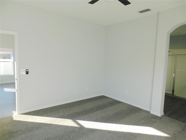 empty room with carpet flooring and ceiling fan