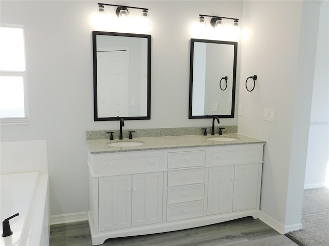 bathroom featuring vanity and a tub to relax in