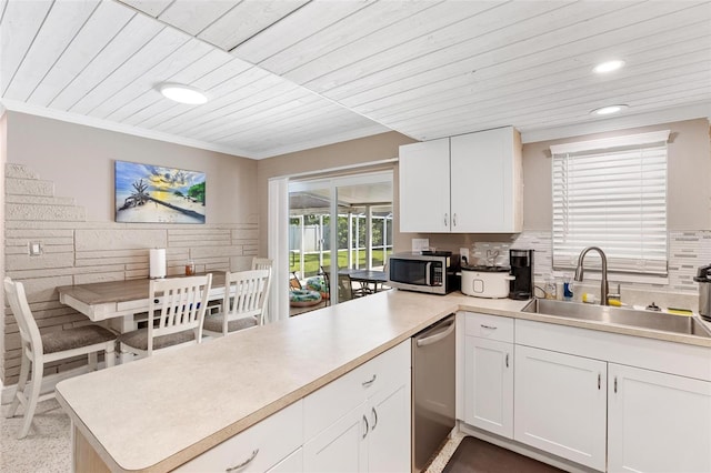 kitchen featuring kitchen peninsula, white cabinetry, sink, and stainless steel appliances