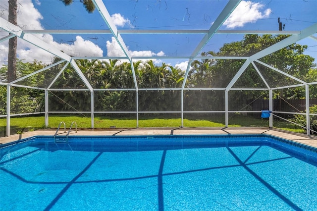 view of swimming pool featuring a lanai