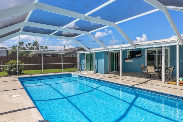 view of pool with a patio area and a lanai