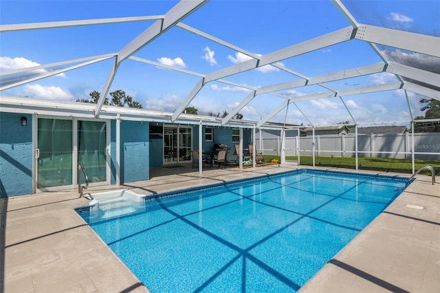 view of swimming pool with glass enclosure and a patio