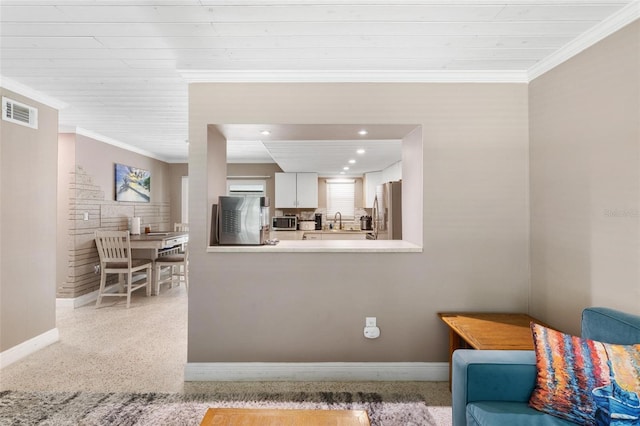 interior space featuring ornamental molding, sink, and wood ceiling