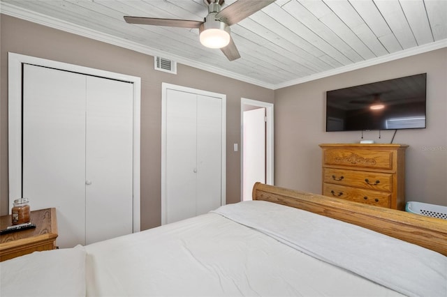 bedroom with ceiling fan, wooden ceiling, two closets, and ornamental molding